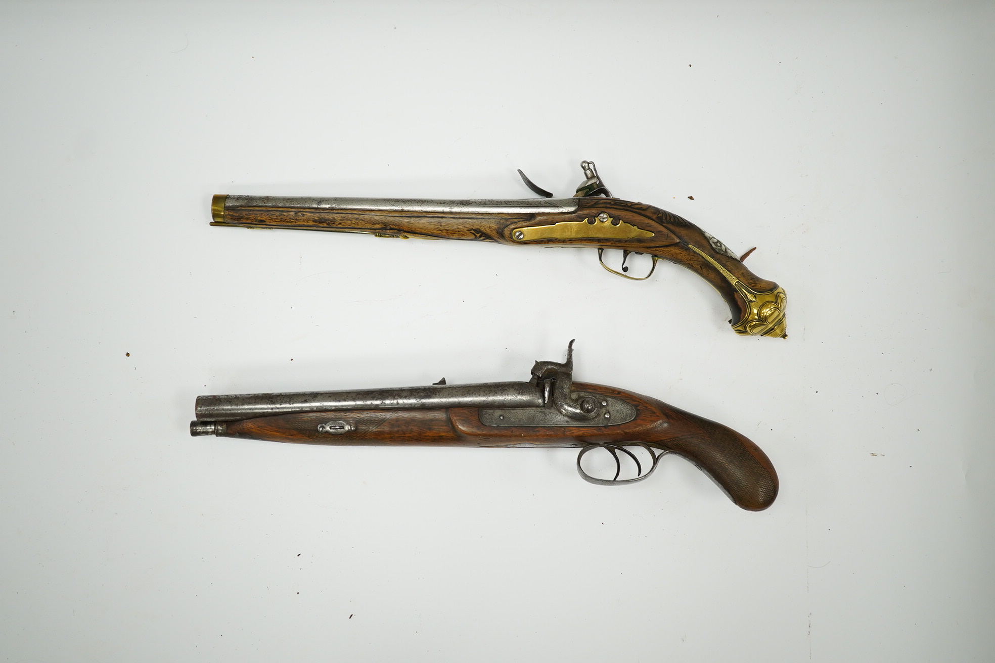 A Turkish flintlock Kubar pistol, with fully stocked brass mounts, polished steel lock and barrel (well worn), barrel 31cm, and a double barrel 12 bore percussion pistol cut down from a sporting gun, barrel 26.5cm, (2).